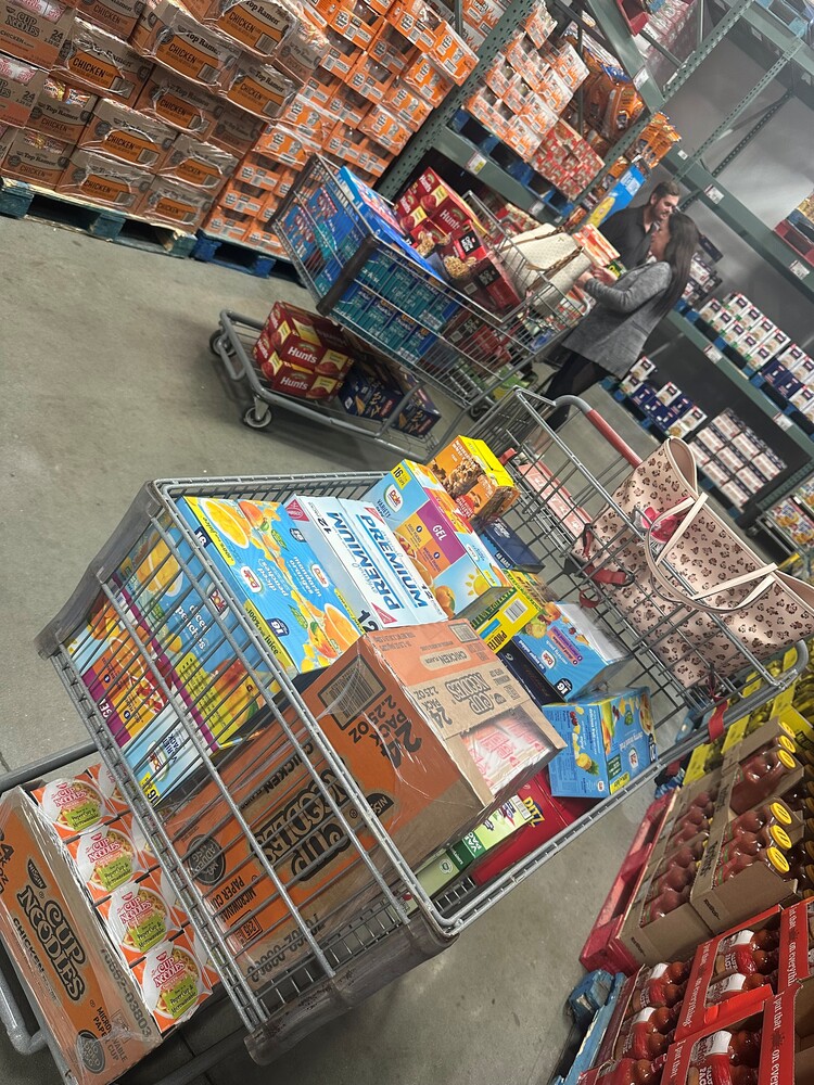 Two shopping carts full of groceries.