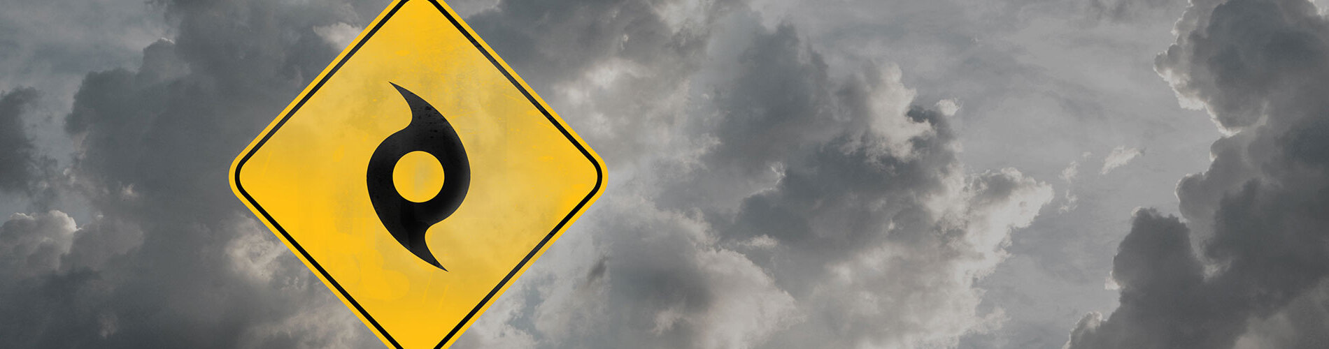 A hurricane sign in front of dark storm clouds.