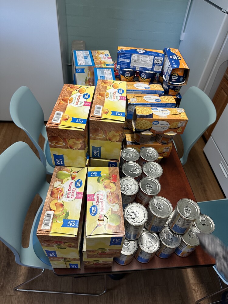 A tabletop full of non-perishable foods like pasta and soup