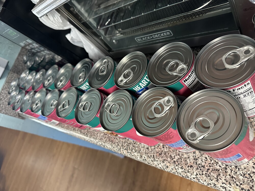 many cans of soup sitting on a countertop