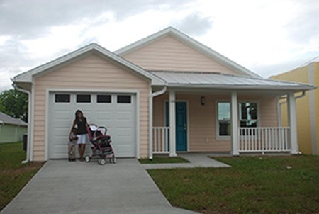 Individuals standing in front of a house