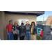 A group of men and women posing in front of the New NSB Resource Center. 