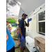  Maintenance man Nate Jenkins standing and waving at the camera wearing latex gloves 