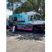  a blue and pink food truck with the name of the restaurant "fat boi" printed on the side 