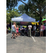  A white outdoor tent with a crowd of people in front of it 